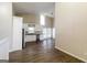Modern kitchen boasts white cabinetry, stainless appliances, and spacious layout with wood-look floors at 6290 Shallowford Way, Douglasville, GA 30135