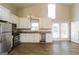 Bright kitchen features stainless appliances, granite counters, and white cabinets and wood-look flooring at 6290 Shallowford Way, Douglasville, GA 30135