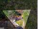 Aerial shot highlights the property lines, showcasing the home's placement on the wooded lot at 9491 Hidden Branch Dr, Jonesboro, GA 30236