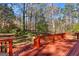 Picture of wooden back deck overlooking green wooded backyard with trees at 9491 Hidden Branch Dr, Jonesboro, GA 30236