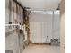 Unfinished basement features exposed utilities against concrete walls and tile floors at 9491 Hidden Branch Dr, Jonesboro, GA 30236