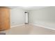 A spare room in the basement with a door, neutral walls and flooring at 9491 Hidden Branch Dr, Jonesboro, GA 30236
