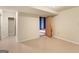 A finished basement with tile floors leading to a carpeted room at 9491 Hidden Branch Dr, Jonesboro, GA 30236