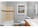 Well-lit bathroom features a shower over bath combination and updated fixtures at 9491 Hidden Branch Dr, Jonesboro, GA 30236