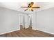 Light and airy bedroom with light hardwood floors, ceiling fan, and closet at 9491 Hidden Branch Dr, Jonesboro, GA 30236