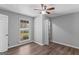 Cozy bedroom featuring a ceiling fan, a window view, and neutral gray walls at 9491 Hidden Branch Dr, Jonesboro, GA 30236