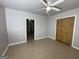 Neutral bedroom featuring tile floors, ceiling fan, closet, and an adjoining room at 9491 Hidden Branch Dr, Jonesboro, GA 30236