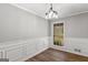 Dining room featuring wood-look flooring and decorative trim at 9491 Hidden Branch Dr, Jonesboro, GA 30236