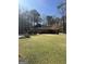 Charming single-story home with a well-manicured lawn and mature trees at 9491 Hidden Branch Dr, Jonesboro, GA 30236