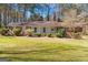 Charming one-story home with a well-maintained front lawn, mature trees, and covered porch at 9491 Hidden Branch Dr, Jonesboro, GA 30236