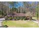 Charming home featuring a well-manicured lawn and a welcoming front porch, surrounded by mature trees and lush greenery at 9491 Hidden Branch Dr, Jonesboro, GA 30236