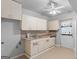 Well-lit kitchen featuring ample cabinetry and a ceiling fan at 9491 Hidden Branch Dr, Jonesboro, GA 30236