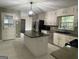Spacious kitchen features a center island with granite countertop and stainless steel appliances at 9491 Hidden Branch Dr, Jonesboro, GA 30236
