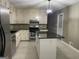 Kitchen showcasing stainless steel appliances, a center island with granite countertop and stylish lighting at 9491 Hidden Branch Dr, Jonesboro, GA 30236