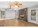 Open living room featuring a stone fireplace, recessed lighting, and wood-look vinyl floors at 9491 Hidden Branch Dr, Jonesboro, GA 30236