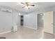 A living room with neutral walls, tile floors, air conditioning, and an open door to another room at 9491 Hidden Branch Dr, Jonesboro, GA 30236