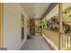 View down a covered porch with brick accents, offering a serene outdoor space at 9491 Hidden Branch Dr, Jonesboro, GA 30236