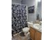 Bathroom with a toilet and shower with floral curtain at 946 Creek Run Pl, Temple, GA 30179