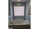 Bathroom with a jacuzzi and window at 946 Creek Run Pl, Temple, GA 30179