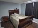 Bedroom featuring a wooden bed frame with a decorative bedspread and a wooden nightstand at 946 Creek Run Pl, Temple, GA 30179