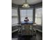 Charming breakfast nook with a unique table and seating, complemented by bright natural light from surrounding windows at 946 Creek Run Pl, Temple, GA 30179