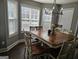 Elegant dining room featuring a spacious wooden table, perfect for Gathering gatherings and entertaining guests at 946 Creek Run Pl, Temple, GA 30179