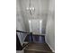 Grand entryway featuring dark wood stairs, modern chandelier, and white door with sidelights at 946 Creek Run Pl, Temple, GA 30179