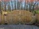 A wooden gate with black iron hardware detail provides private access to the home at 946 Creek Run Pl, Temple, GA 30179