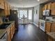 Well-equipped kitchen featuring wood cabinets, granite countertops, and a dining nook at 946 Creek Run Pl, Temple, GA 30179