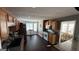 Spacious kitchen with wood cabinets, granite counters, and a view into a dining area at 946 Creek Run Pl, Temple, GA 30179