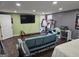 Open living room featuring a blue sofa, television, desk, and a bed at 946 Creek Run Pl, Temple, GA 30179
