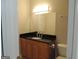 This bathroom features tile flooring and a large mirror over a wood vanity with black countertop at 117 Rondak Se Cir, Smyrna, GA 30080