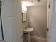 Cozy half bath with a pedestal sink, decorative mirror, and clean white walls at 117 Rondak Se Cir, Smyrna, GA 30080