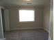 This bedroom has gray carpet, white trim and a window with bright light at 117 Rondak Se Cir, Smyrna, GA 30080