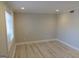 Bright, empty bedroom with neutral walls, ample natural light from the window, and stylish wood-look flooring at 117 Rondak Se Cir, Smyrna, GA 30080