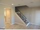 Attractive staircase featuring carpeted steps, modern railings, neutral wall colors, and hardwood floors at 117 Rondak Se Cir, Smyrna, GA 30080