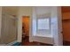 Bathroom featuring a soaking tub, glass-enclosed shower, and walk-in toilet area at 7926 Palomino Pass, Riverdale, GA 30274