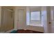 Bright bathroom featuring a soaking tub beneath a window and a glass-enclosed shower at 7926 Palomino Pass, Riverdale, GA 30274