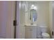 Half bathroom featuring a vanity, toilet, and a bright ambiance, adding comfort and convenience to the home at 7926 Palomino Pass, Riverdale, GA 30274