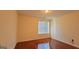 Sunlit bedroom with hardwood floors and a large window at 7926 Palomino Pass, Riverdale, GA 30274