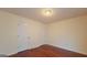 Bright bedroom features warm hardwood floors and neutral walls, illuminated by a ceiling light at 7926 Palomino Pass, Riverdale, GA 30274