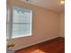 Bedroom with hardwood floors and natural light entering through a large window with blinds at 7926 Palomino Pass, Riverdale, GA 30274