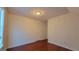 Sunlit bedroom featuring hardwood floors, neutral walls, and a door at 7926 Palomino Pass, Riverdale, GA 30274