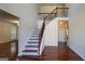 A grand foyer with high ceilings, gleaming hardwood floors, and a staircase with decorative iron railings at 7926 Palomino Pass, Riverdale, GA 30274