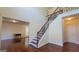 Welcoming foyer with gleaming hardwood floors, a staircase with iron railings, and a glimpse into the living area at 7926 Palomino Pass, Riverdale, GA 30274