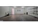 Two-car garage with shelving, offering ample space for vehicles and storage needs, ensuring functionality and convenience at 7926 Palomino Pass, Riverdale, GA 30274