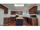 Updated kitchen with a black center island, wood cabinets, and white countertops at 7926 Palomino Pass, Riverdale, GA 30274