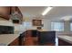 Kitchen boasts hardwood floors, a center island, updated appliances, and ample cabinet space at 7926 Palomino Pass, Riverdale, GA 30274