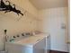 Laundry area with a full size washing machine and dryer, and a wire rack shelf at 7926 Palomino Pass, Riverdale, GA 30274