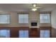 Bright living room boasts hardwood floors, a fireplace, and three large windows for natural light at 7926 Palomino Pass, Riverdale, GA 30274